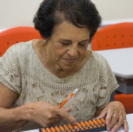 Mulher idosa fazendo atividades no ábaco